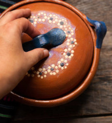 Traditional mexican clay pot also called cazuela on wooden background