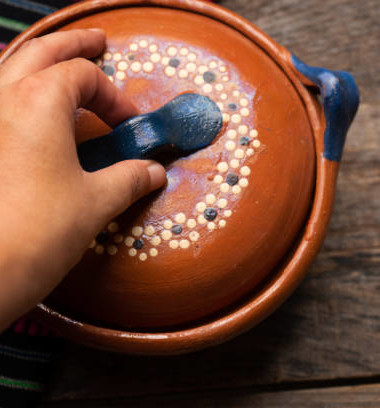Traditional mexican clay pot also called cazuela on wooden background